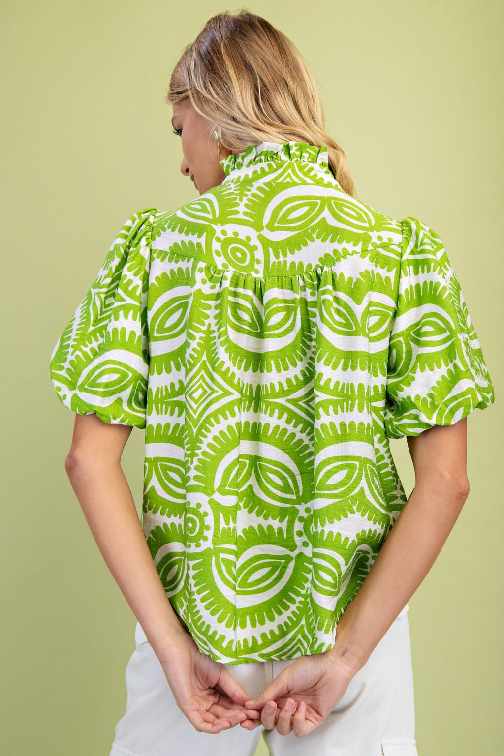 Stylish Mazey Green Top from a Port Aransas boutique, perfect for tropical vacations and curated women's fashion.