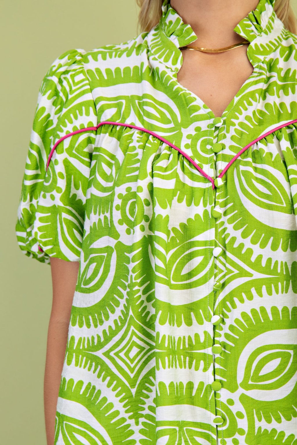 Stylish Mazey Green Top from a Port Aransas boutique, featuring vibrant patterns, ideal for tropical vacation dresses.