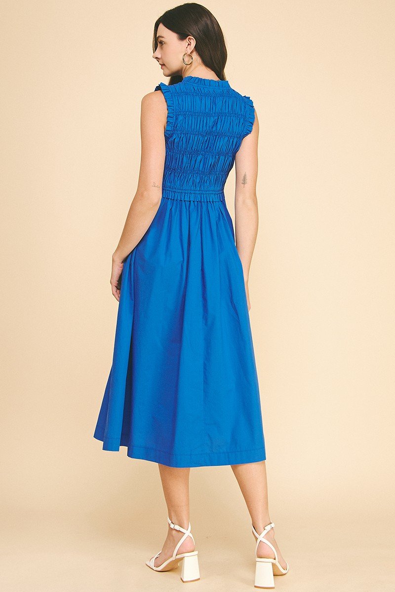 Back view of Summer Blue Midi Dress featuring smocking and a flattering silhouette, perfect for coastal boutique clothing.