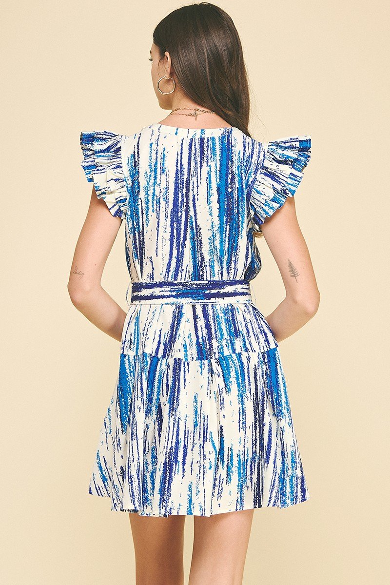 Back view of a blue multi-print mini dress with ruffled sleeves, perfect for coastal boutique clothing and beach outings.