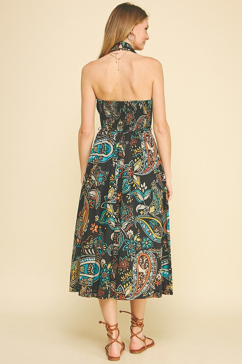 Back view of the Camela Dress, a boho-chic paisley maxi dress. Ideal for coastal boutique clothing and beach vacations.