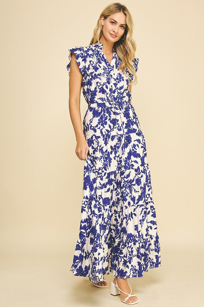 Elegant blue floral printed tiered maxi dress from a Port Aransas boutique, perfect for beach outings or special occasions.