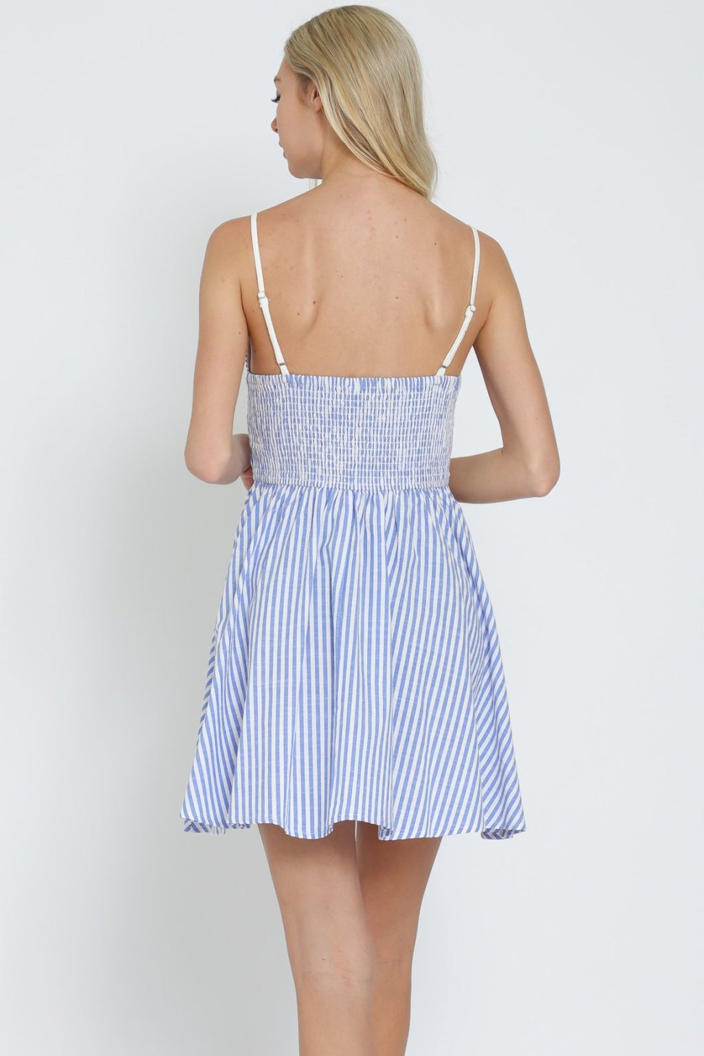 Back view of a blue & white striped strap mini dress, ideal for summer from a coastal boutique clothing selection.