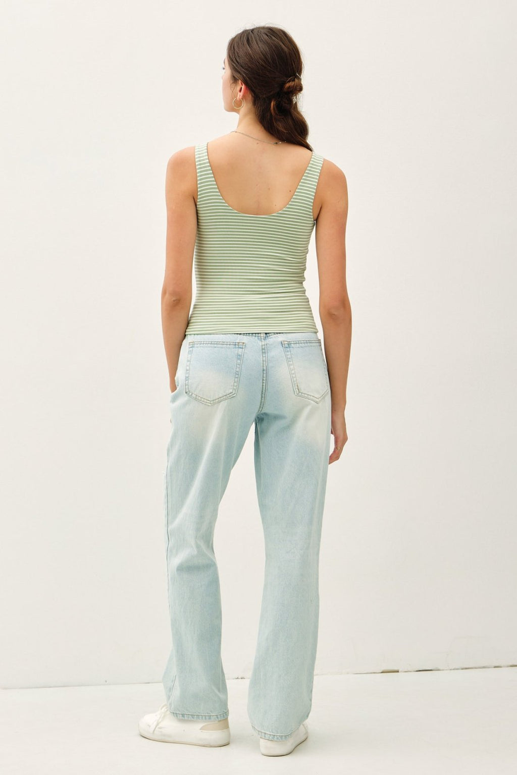 Pistachio stripe tank top styled with light wash jeans, perfect for coastal boutique clothing and summer layering.