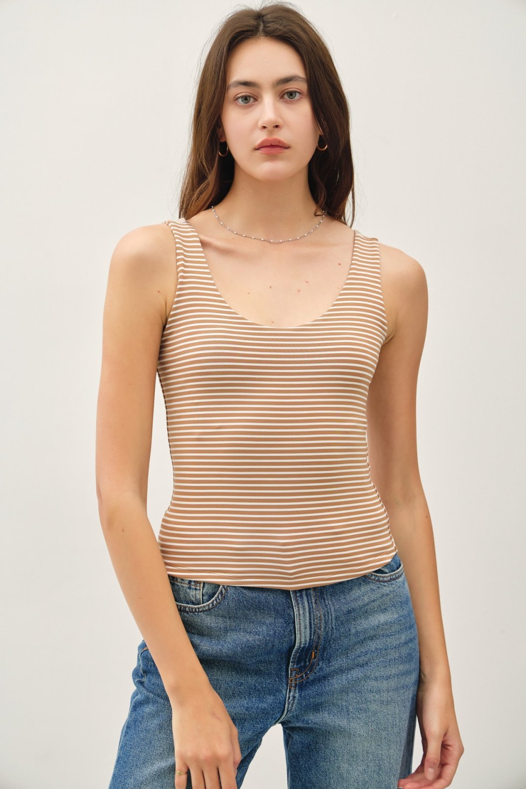 Mocha stripe double-lined tank top, perfect for layering and summer style at a coastal boutique clothing store.