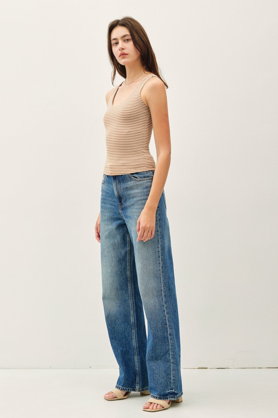 Mocha stripe double-lined tank top paired with wide-leg jeans, ideal for summer layering, from a coastal boutique in Port Aransas.