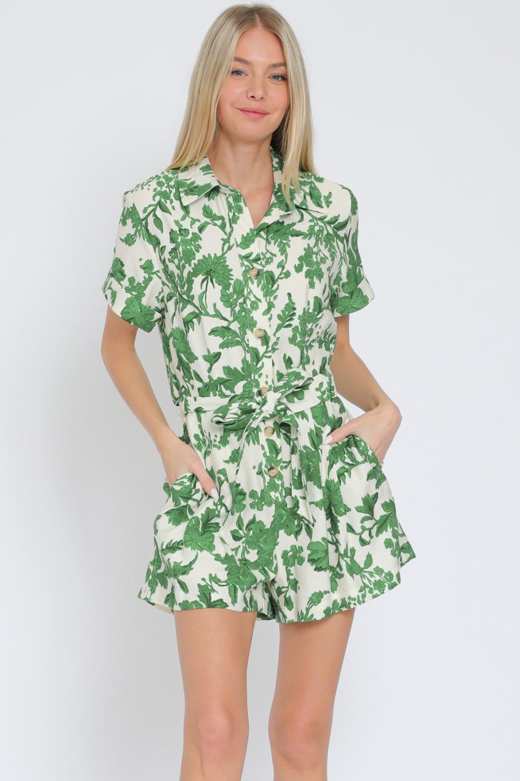 Ivory and green short sleeve romper with collared neckline from a Port Aransas boutique, perfect for coastal vacations.