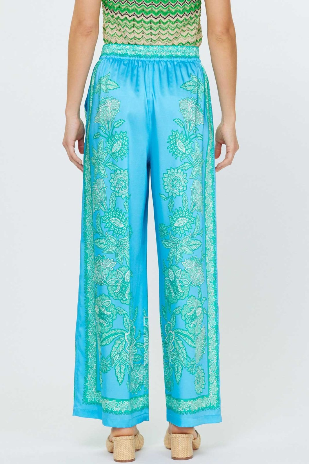 Aqua blue paisley floral printed wide-leg pants from a coastal boutique. Ideal for spring and summer fashion.
