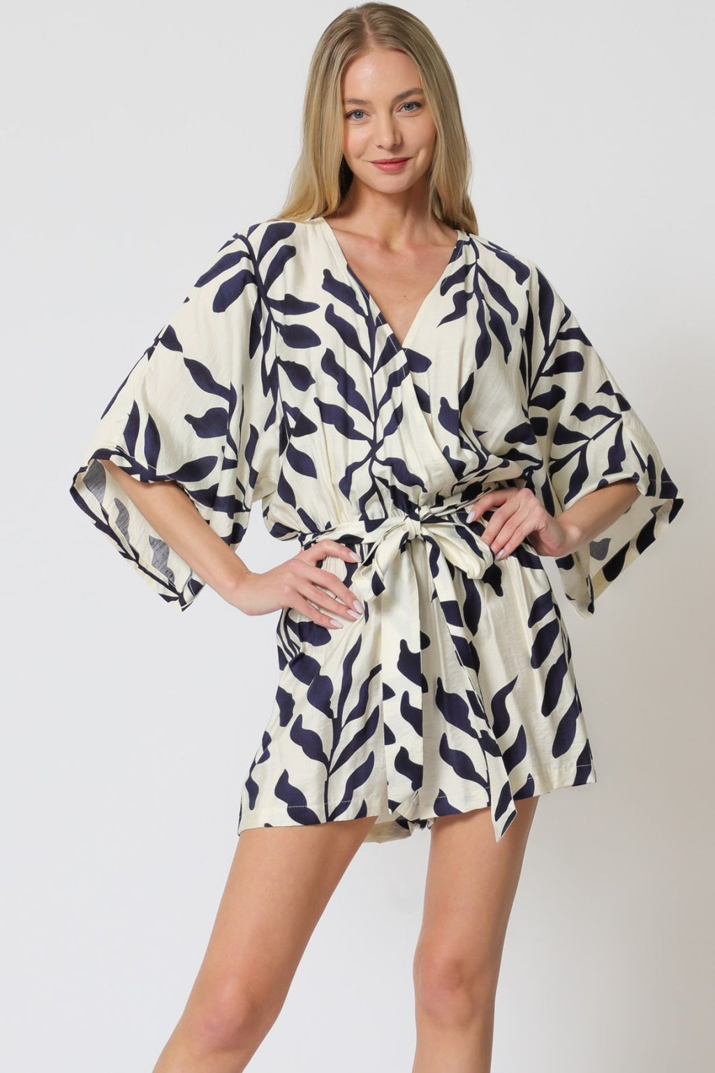 Stylish ivory and navy Vivian romper at a coastal boutique, perfect for tropical vacations and curvy plus size fashion.