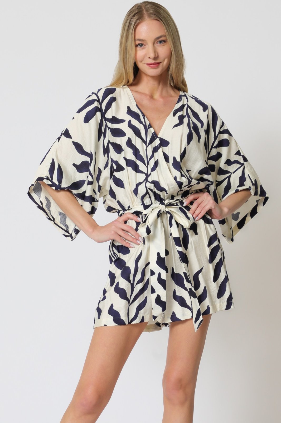 Stylish ivory and navy Vivian romper at a coastal boutique, perfect for tropical vacations and curvy plus size fashion.
