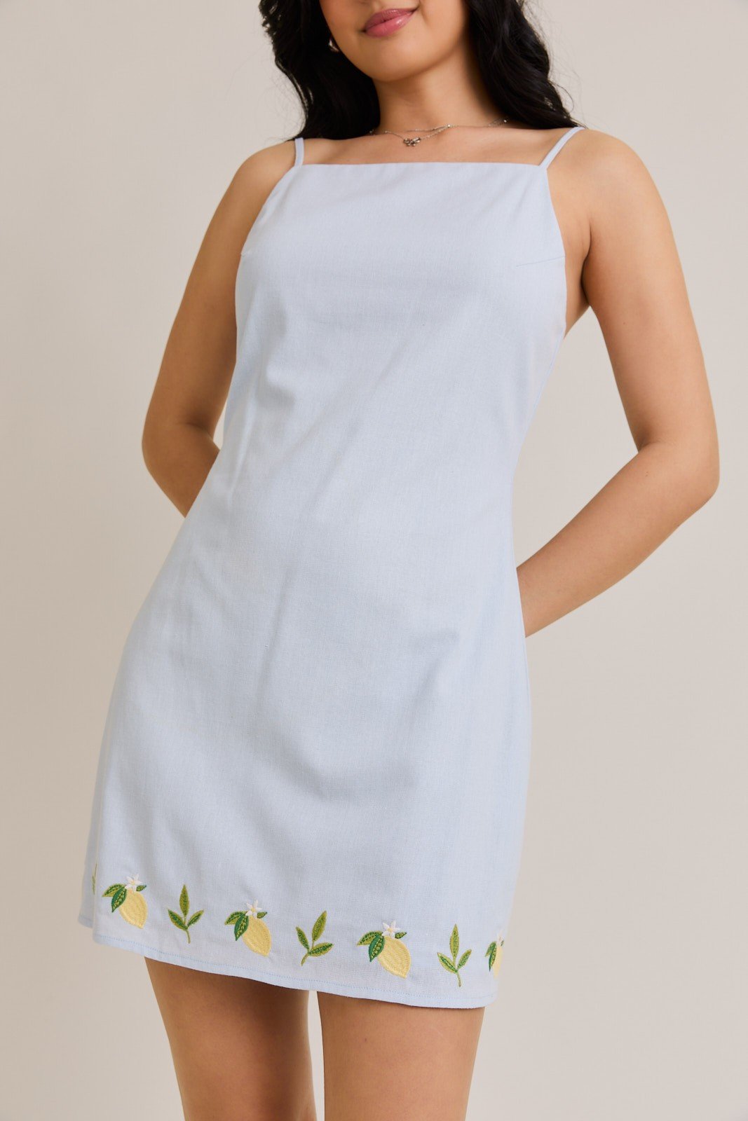 Light blue lemon drop mini dress from Port Aransas boutique, perfect for beach outings and stylish summer fashion.
