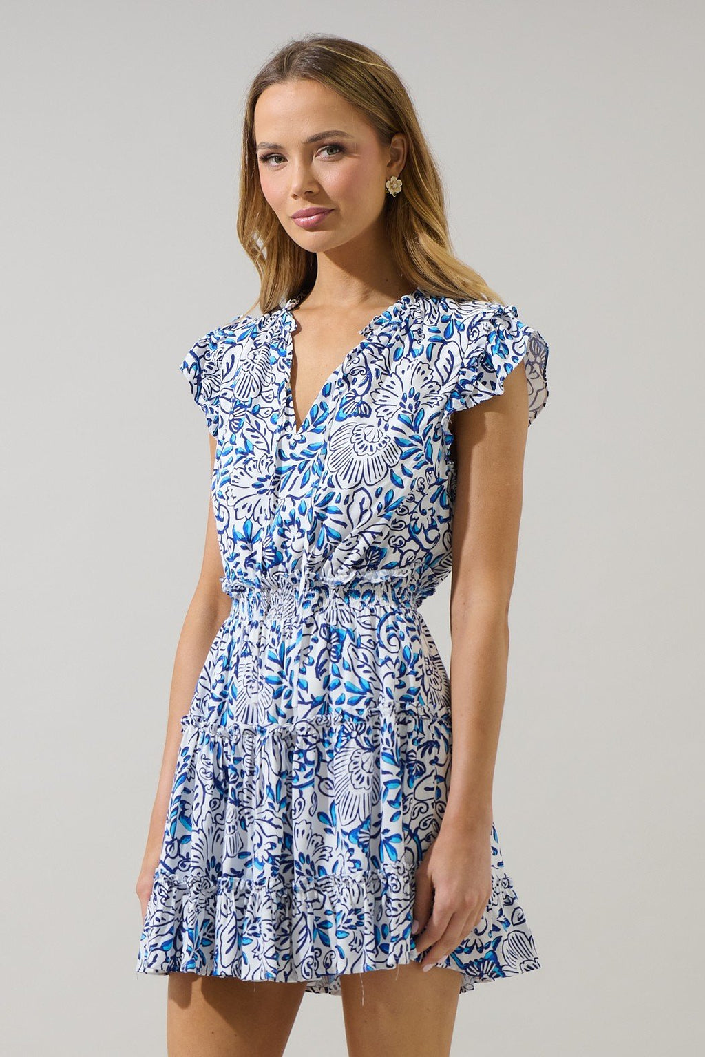 Flora Dress showcasing a floral print mini dress from a coastal boutique, perfect for beach dresses and tropical vacations.
