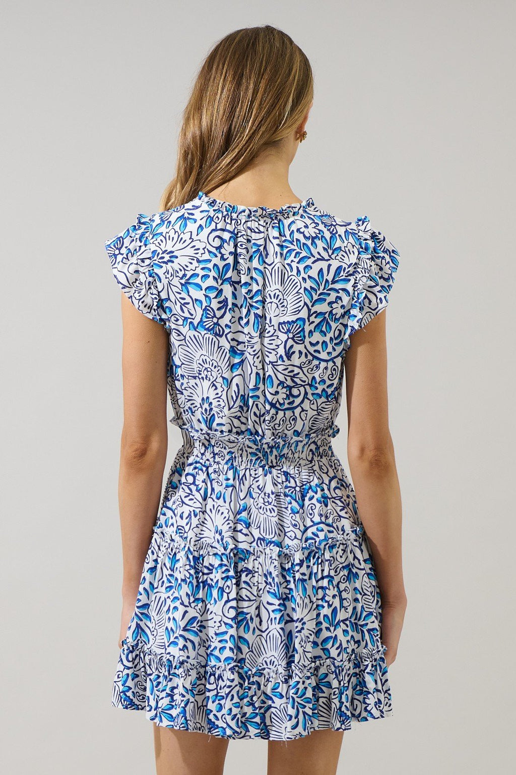 Back view of Mize Floral Toledo Mini Dress, a stylish piece from a Port Aransas boutique, perfect for coastal vacations.