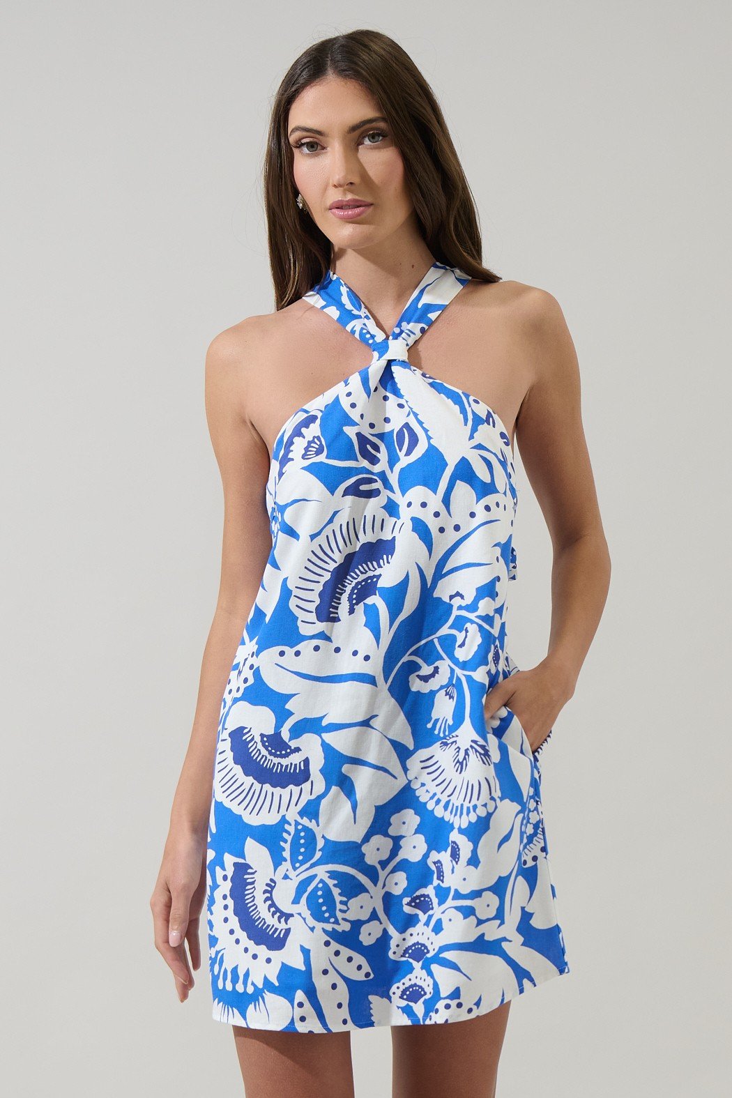 Amory Halter Dress in blue and white floral, perfect for beach outings and summer styles at coastal boutiques.