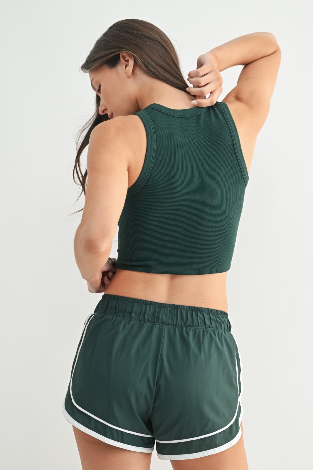 Stylish seam-free evergreen muscle tank paired with comfy shorts, perfect for beach days and casual summer outings.