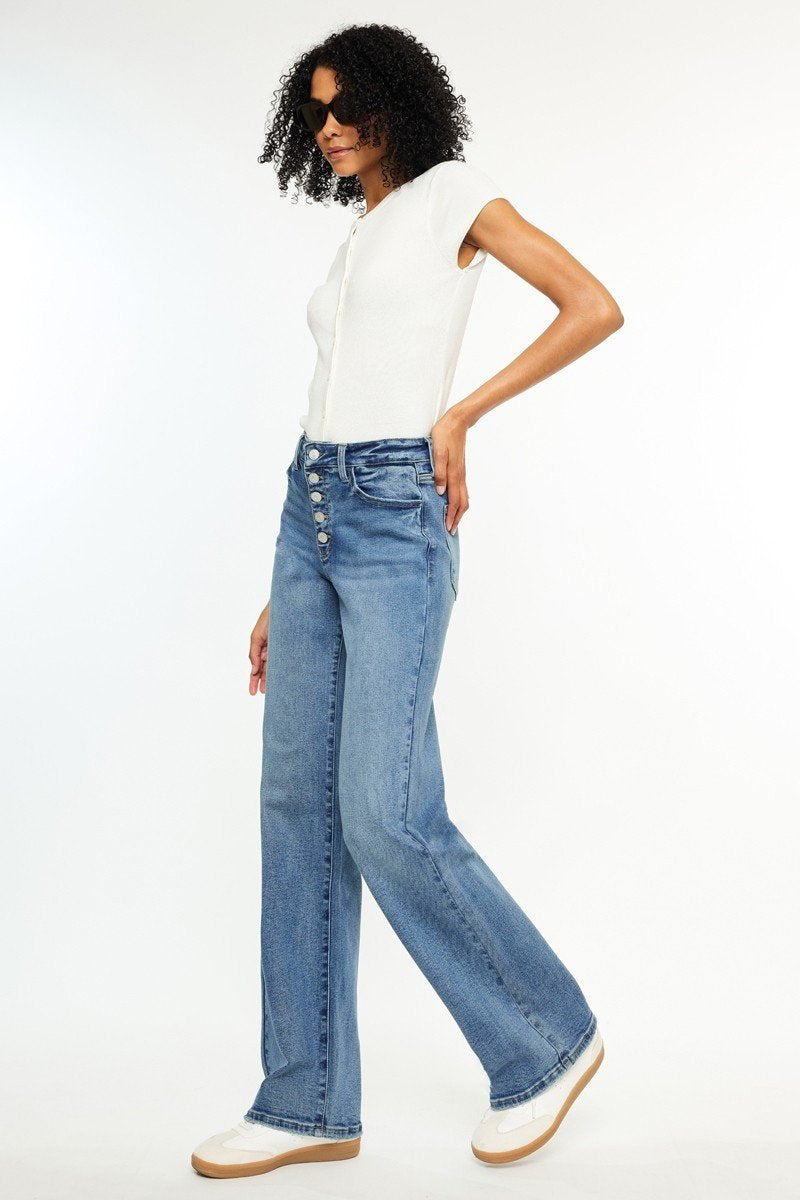 Model showcasing Twilight Retro HR 90’s Flare Jeans -KanCan from a coastal boutique, perfect for stylish women's fashion.