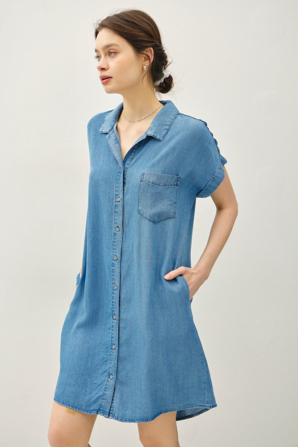 Medium wash Tencel dress from a Port Aransas boutique, perfect for beach outings and stylish summer wear.