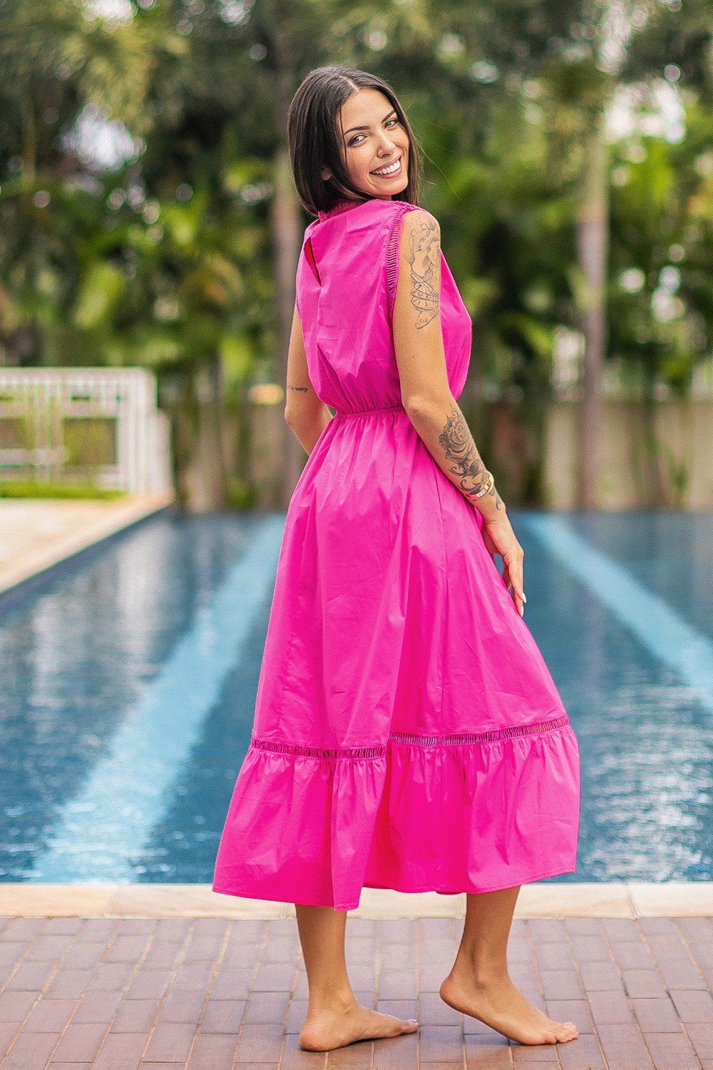 Model showcasing a LOVE PINK DRESS by Raggdoll Boutique, perfect for summer outfits in Port Aransas.