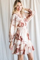 SWEET SWIRL PRINT DRESS WITH RUFFLE TRIM modeled by a woman, showcasing trendy coastal style from Raggdoll Boutique.