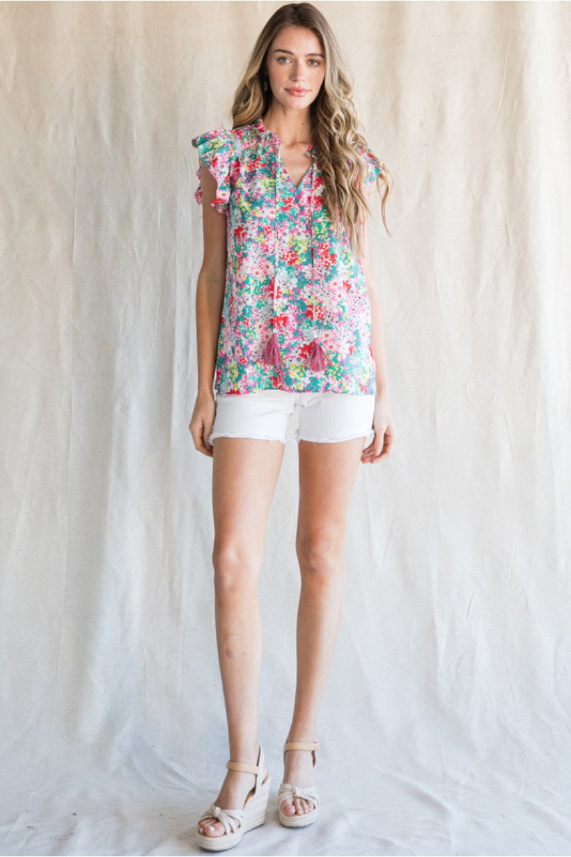 PINK, YELLOW GREEN FLORAL TOP worn with white shorts, showcasing trendy coastal style from Raggdoll Boutique.