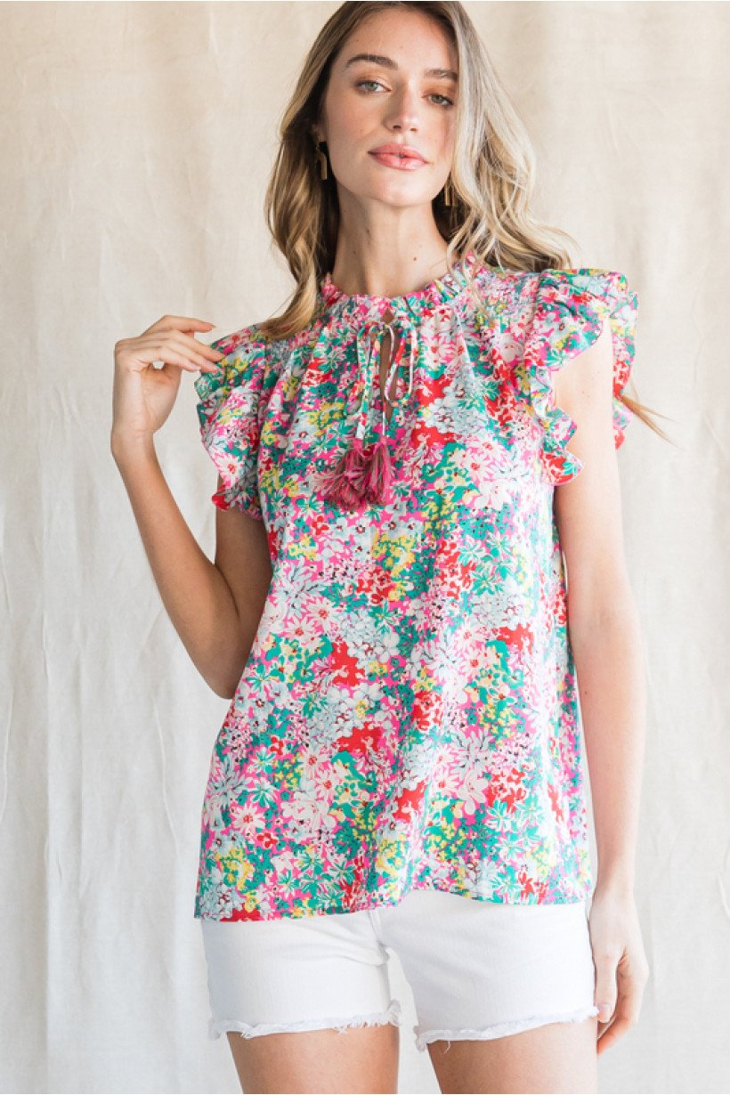 PINK, YELLOW GREEN FLORAL TOP from Raggdoll Boutique featuring ruffled shoulders and tassel neck, perfect for summer outfits Texas.