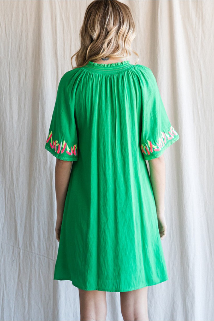 Back view of the IN THE TROPICS DRESS showcasing vibrant green color and detailed sleeves, perfect for summer outfits Texas.