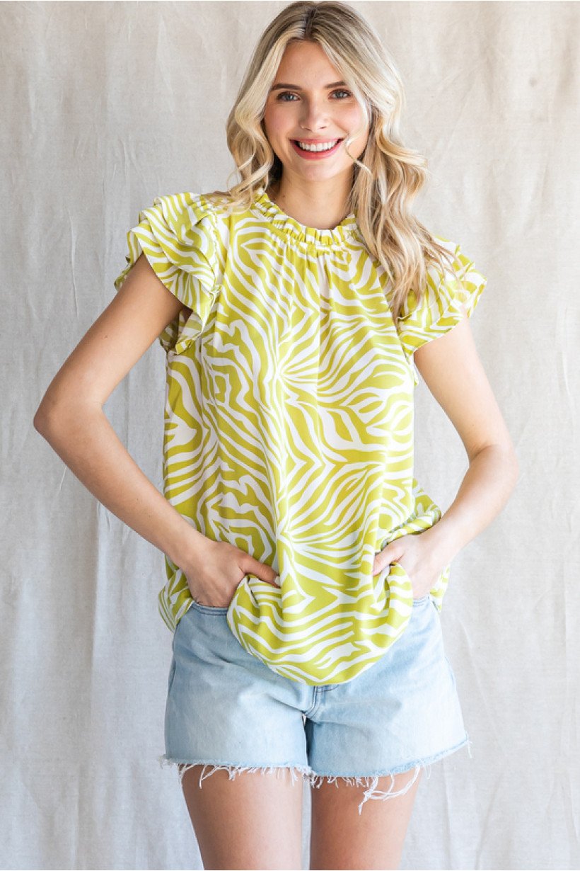 Lime and white print top on model with denim shorts, perfect for coastal boutique clothing and stylish summer outfits.