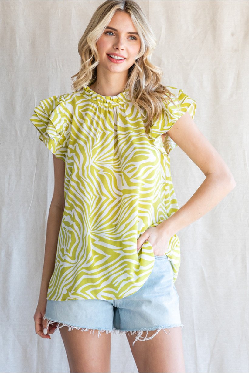 Lime and white print top featured at a coastal boutique, perfect for beach dresses and stylish women's fashion.