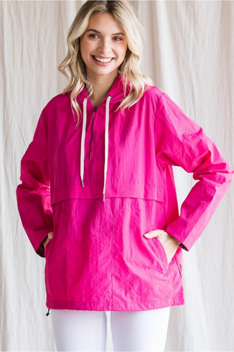 Bright pink windbreaker pullover with a hood, perfect for coastal boutique clothing and stylish tops for women.