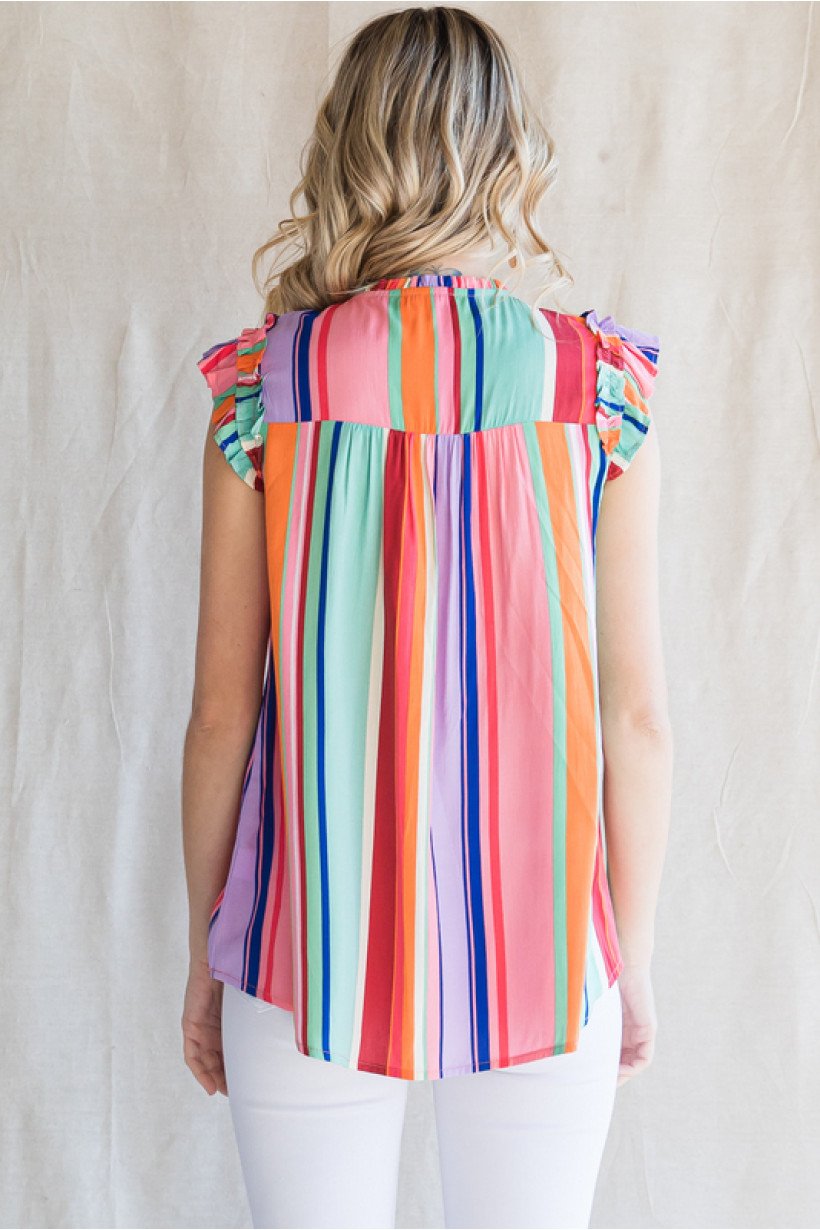 Back view of a woman wearing a MULTI-STRIPE TOP from Raggdoll Boutique, perfect for coastal fashion.