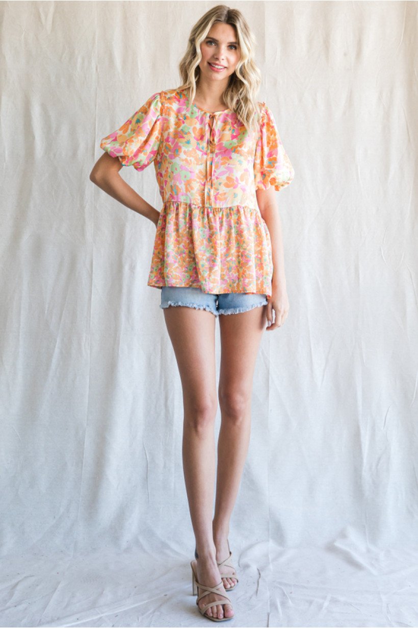 PINK, YELLOW AND TURQUOISE TOP showcased with shorts at Raggdoll Boutique for trendy coastal style.