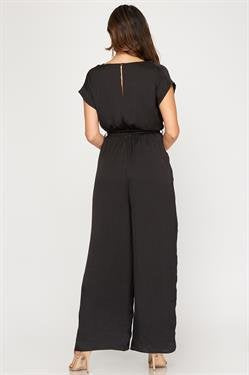 Back view of CLASSIC! BLACK SATIN JUMPSUIT featuring short sleeves and waist sash from Raggdoll Boutique.