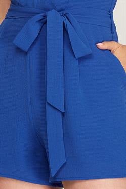 Close-up of the ROYAL BLUE CLASSIC ROMPER with a stylish tie belt, perfect for vacation wardrobe boutique.
