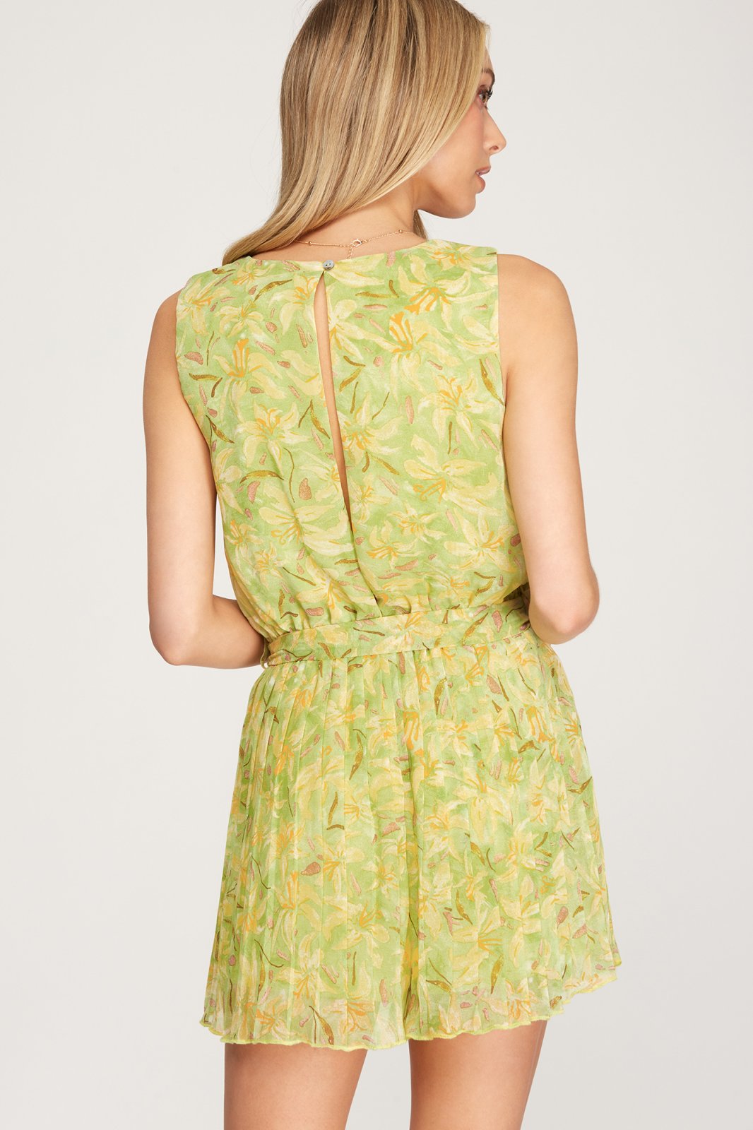 Back view of SWEET LIME ROMPER from Raggdoll Boutique, featuring a vibrant green floral design perfect for summer outfits Texas.