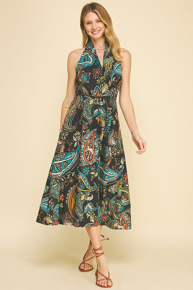 Boho-chic paisley halter neck maxi dress from a coastal boutique, perfect for summer beach vacations and stylish events.
