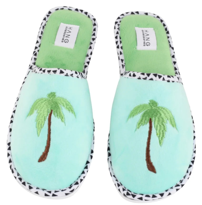 Mint green slippers with palm tree embroidery, perfect for cozy evenings and tropical vibes at coastal boutique clothing stores.