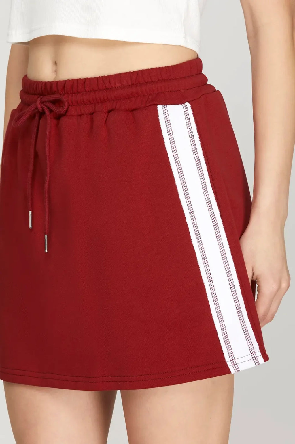 Maroon mini skirt with elastic waistband, sporty contrast stripes, perfect for coastal boutique clothing and curvy plus size fashion.