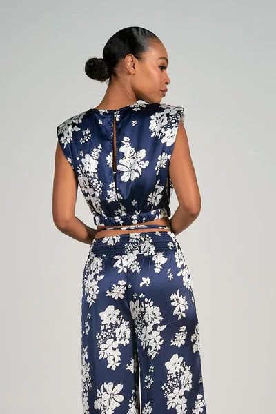 Stylish navy floral crop top and matching pants from a coastal boutique, perfect for tropical vacation outfits.
