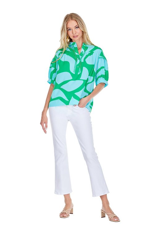 Stylish green patterned Arial Top paired with white jeans, perfect for coastal boutique clothing and tropical vacations.
