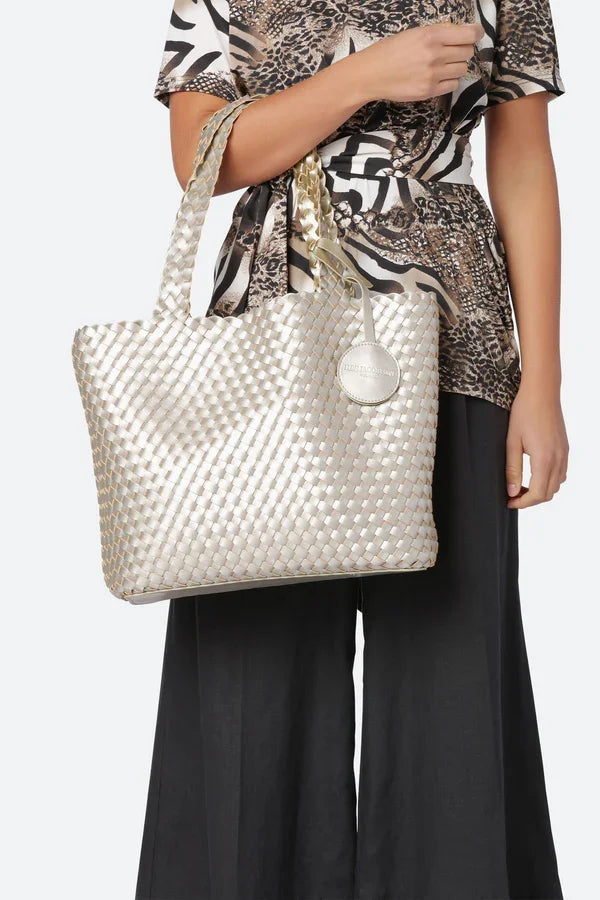 Ilse Jacobsen Platin reversible tote bag in silver, styled with women's fashion at a coastal boutique.