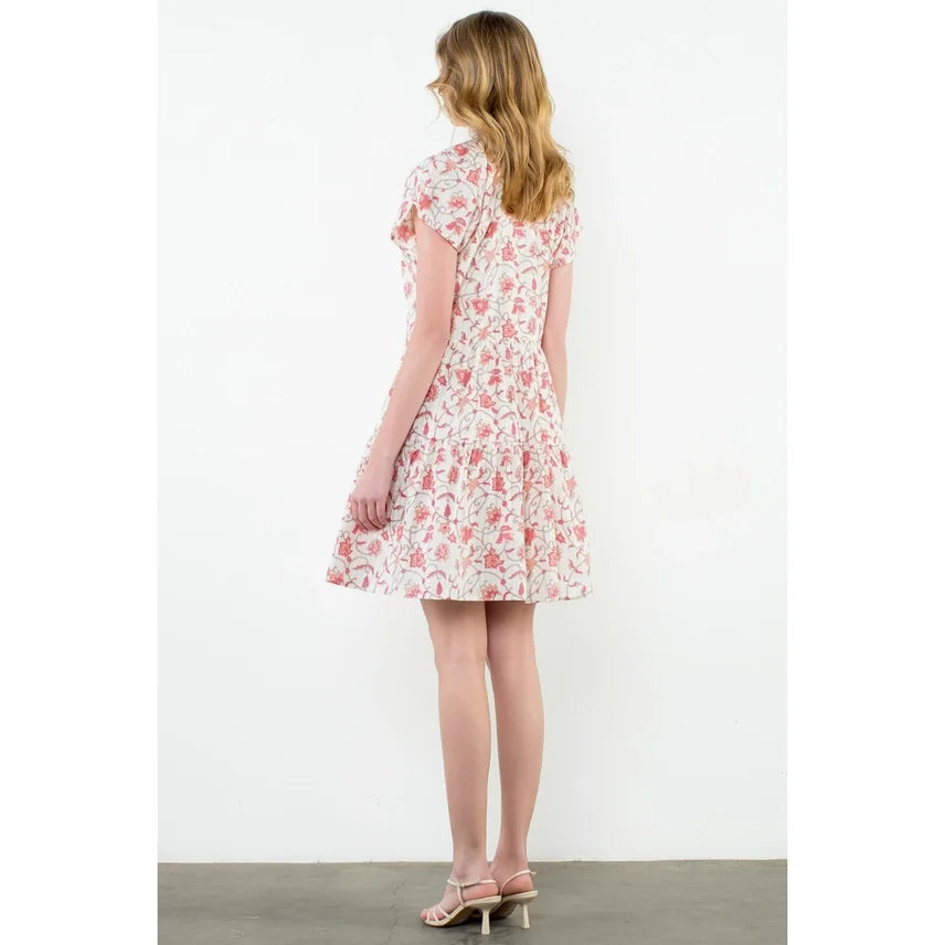 Back view of a cream floral button-up dress, perfect for coastal boutique clothing and tropical vacation dresses.