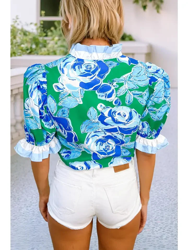 Kelley Top in vibrant floral design, perfect for coastal boutique clothing, paired with white shorts for a chic look.