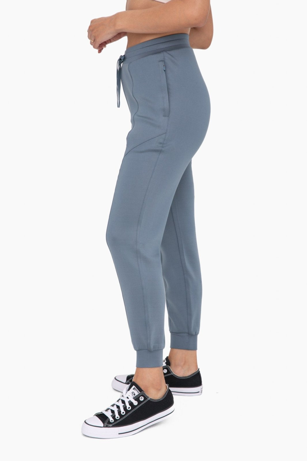 Stylish blue cuffed joggers with zipper pockets, perfect for coastal boutique clothing and casual outfits, featuring Modal blend.