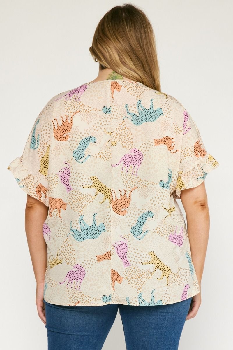 PLUS CREAM MULTI CHEETAH TOP showcasing a trendy coastal style. Ideal for vacation wardrobe and summer outfits.