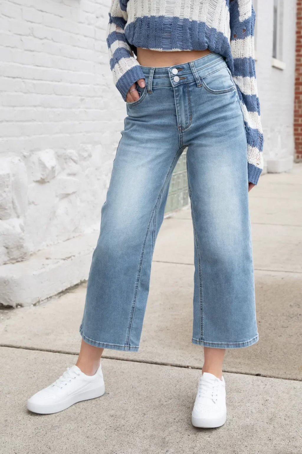 Model showcasing JUDY BLUE HW DOUBLE WB CROP WIDE JEAN with trendy coastal style in Port Aransas