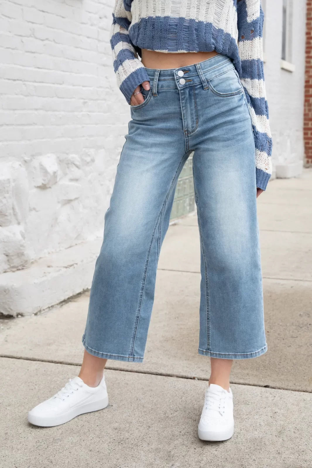 Model showcasing JUDY BLUE HW DOUBLE WB CROP WIDE JEAN with trendy coastal style in Port Aransas