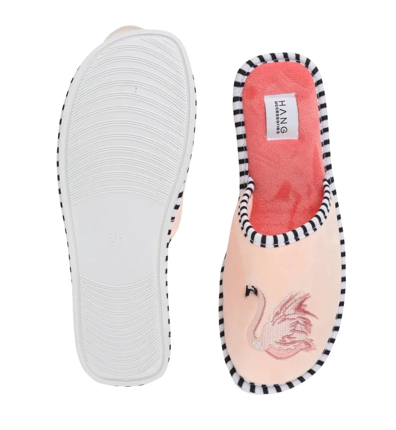 Pink flamingo slippers with striped edges, perfect for the beach or lounging, from a Port Aransas boutique.