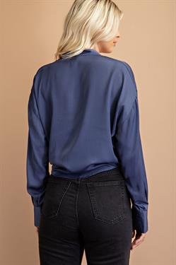 Woman wearing an indigo tie front crop top with sleeve cuffs, showcasing stylish women's fashion from a coastal boutique.