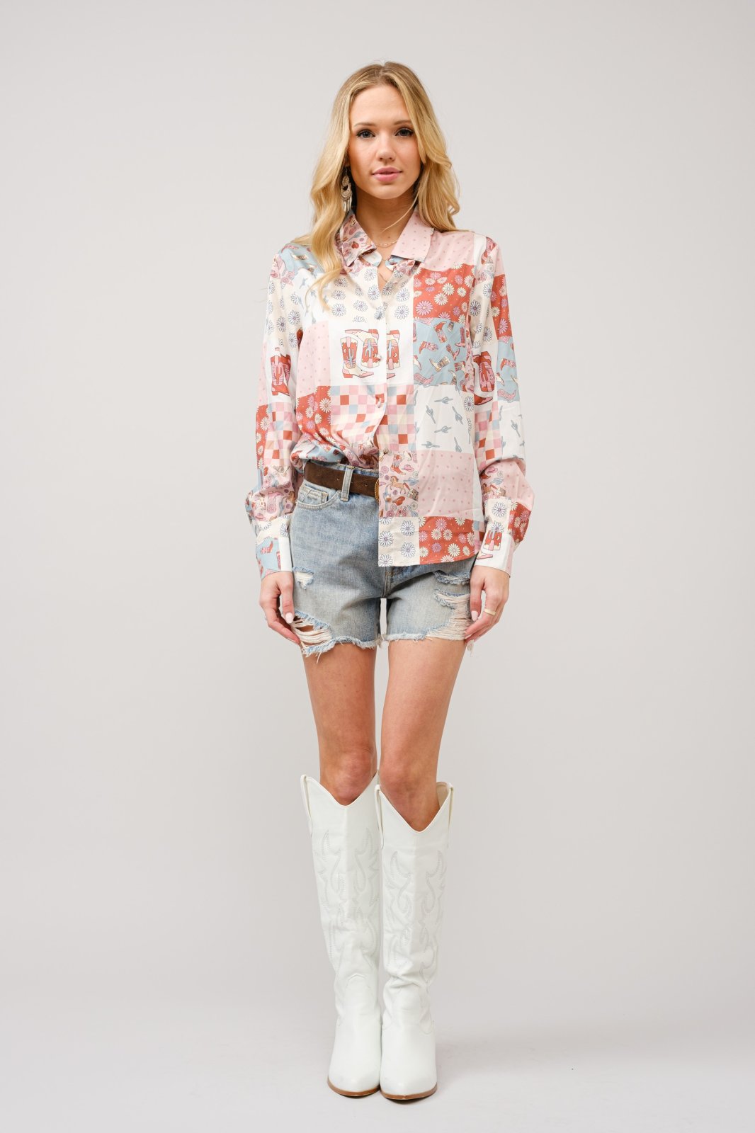 Stylish Western motif button front top paired with denim shorts and white cowgirl boots, perfect for coastal boutique clothing.