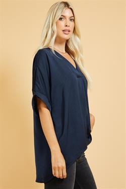 Model showcasing the NAVY SATIN HI-LO TOP from Raggdoll Boutique, perfect for trendy coastal style.